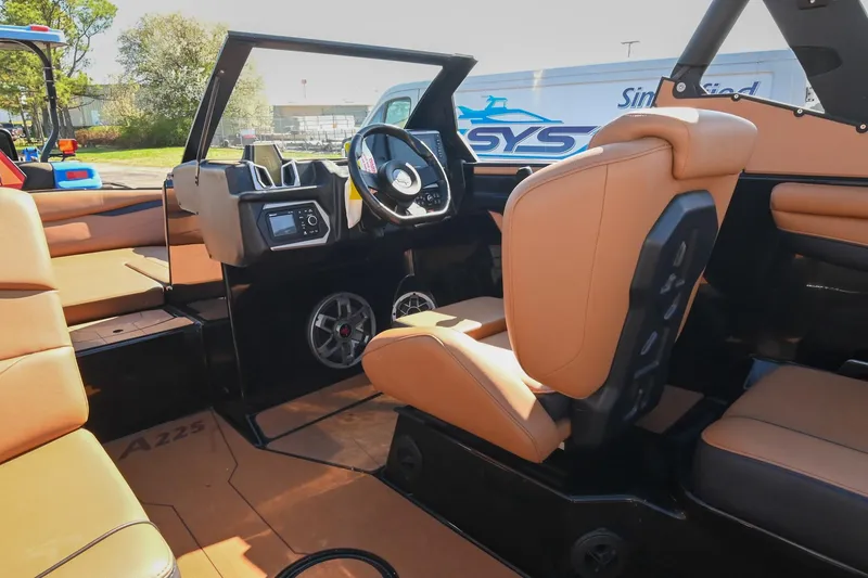 Slide: The Image of 2023 Axis A225 boat interior with tan seating and modern dashboard design. - 30