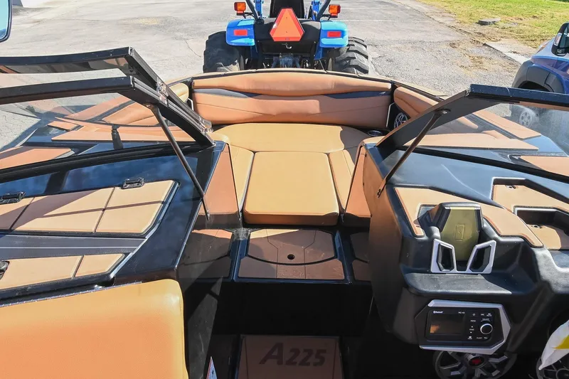 Slide: The Image of 2023 Axis A225 boat interior with tan seating and modern dashboard design. - 36