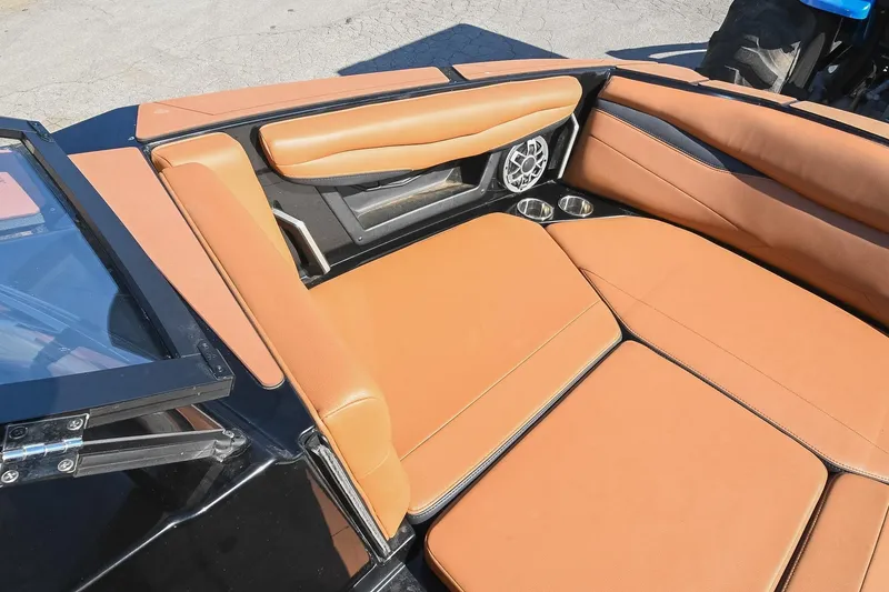 Slide: The Image of 2023 Axis A225 boat interior with tan leather seats and cup holders. - 38