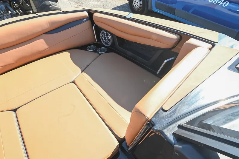 Slide: The Image of 2023 Axis A225 boat interior with tan leather seating and cup holders. - 39