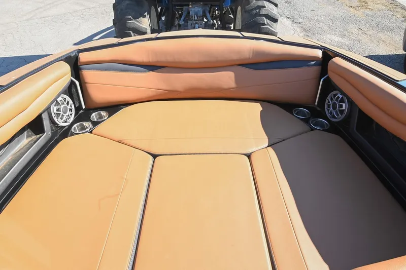 Slide: The Image of 2023 Axis A225 boat interior with tan seating, cup holders, and speakers. - 40