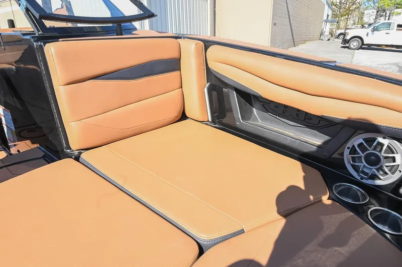 Slide: The Image of 2023 Axis A225 boat interior with tan leather seats and speaker system. - 41