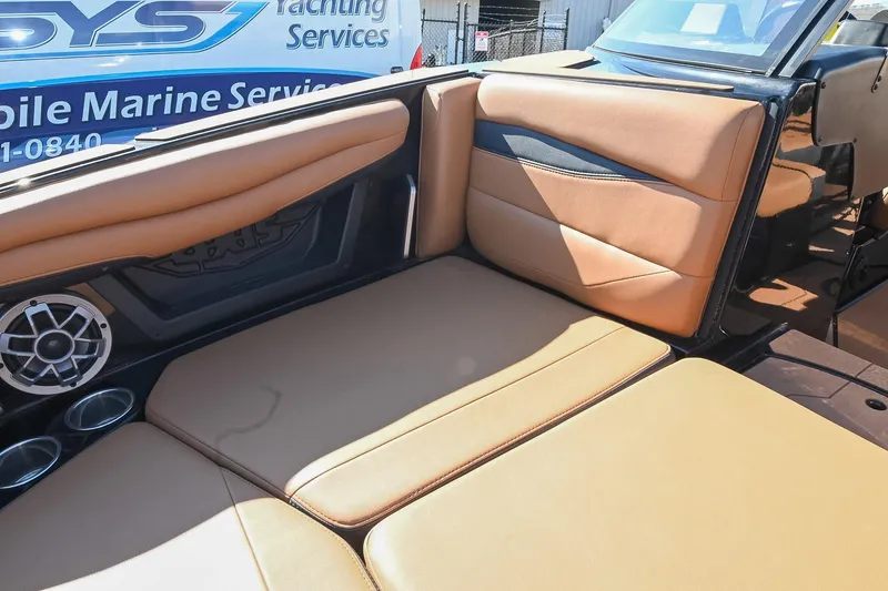 Slide: The Image of 2023 Axis A225 boat interior with tan seating and speaker system. - 42