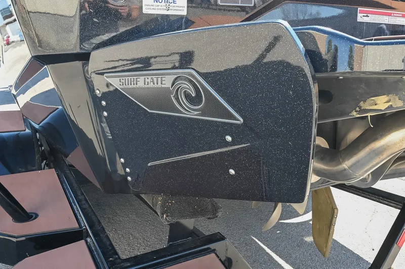 Slide: The Image of 2023 Axis A225 boat with Surf Gate technology, featuring sleek black design. - 6