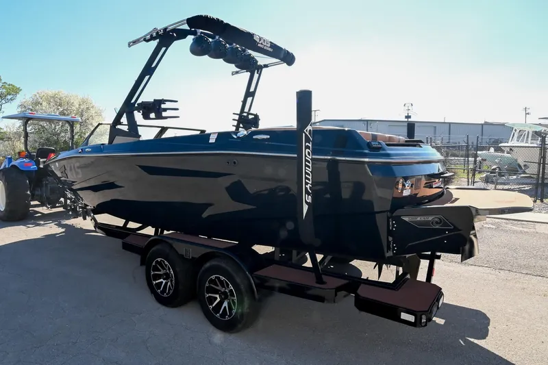 Slide: The Image of 2023 Axis A225 boat on trailer, sleek design, parked outdoors. - 7