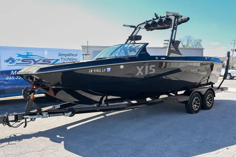 Slide: The Image of 2023 Axis A225 boat on trailer, displayed outdoors with clear sky background. - 9
