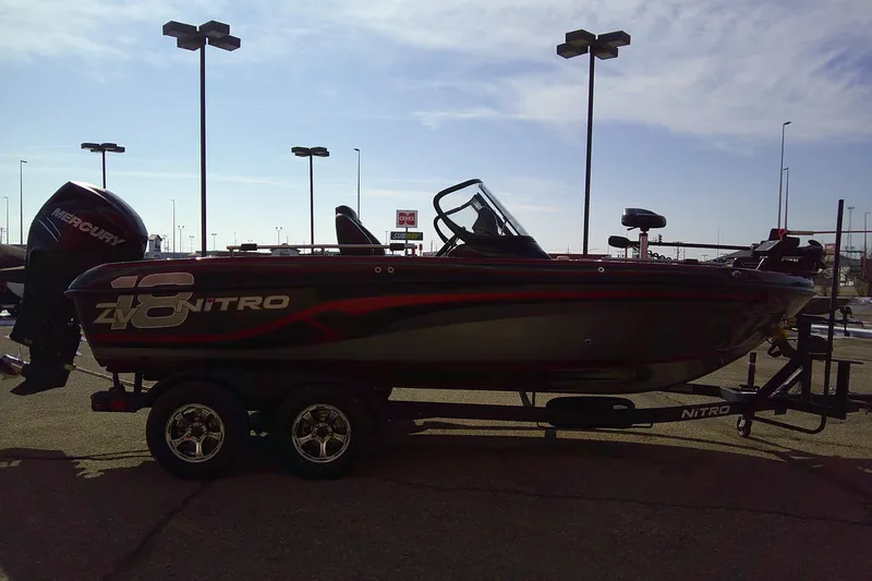 Slide: The Image of 2018 Nitro ZV18 boat on trailer with Mercury engine, parked outdoors. - 4