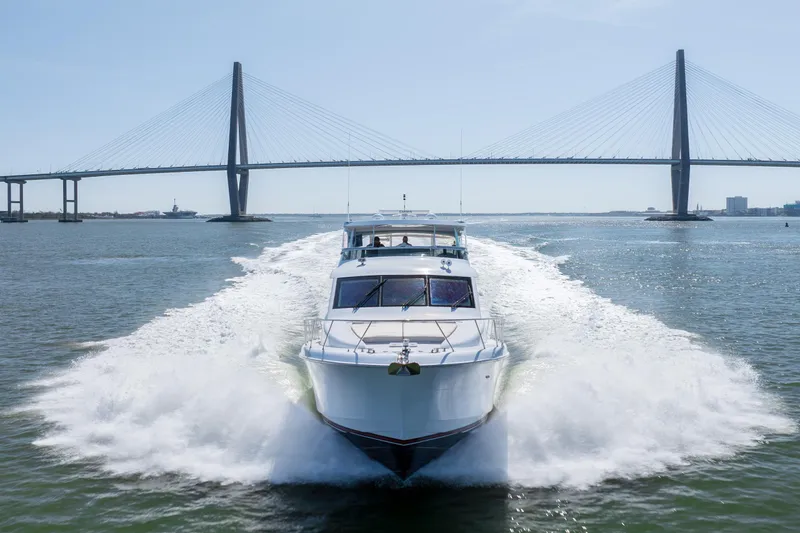 The Image of 2007 Hatteras 64 Motor Yacht cruising under a large suspension bridge. - 1