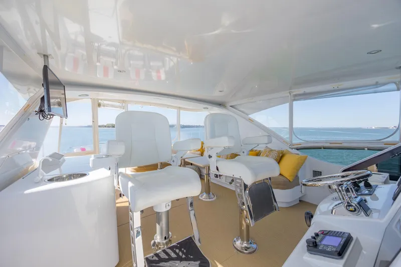 Slide: The Image of Luxurious interior of 2007 Hatteras 64 Motor Yacht with plush seating and ocean view. - 11