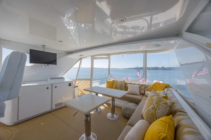 Slide: The Image of Luxurious interior of 2007 Hatteras 64 Motor Yacht with elegant seating and ocean view. - 13