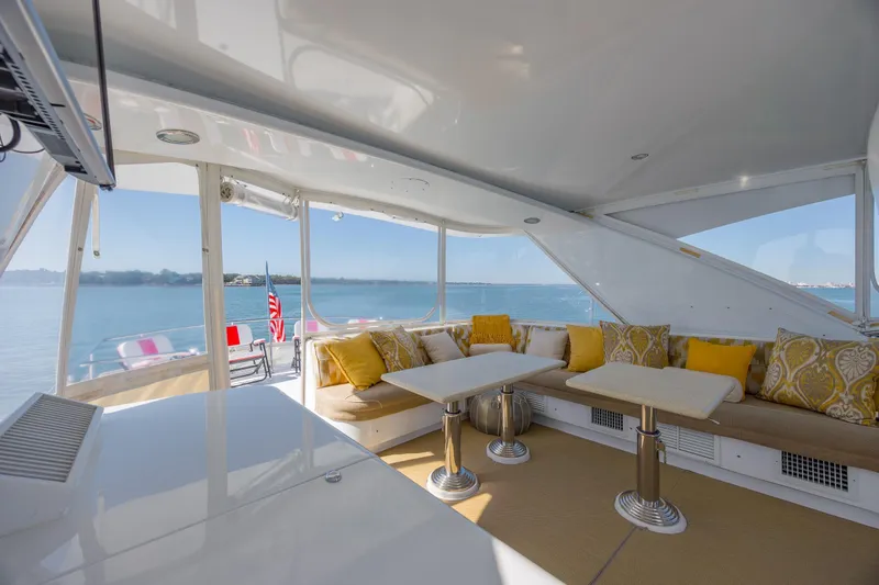 Slide: The Image of Luxurious 2007 Hatteras 64 Motor Yacht interior with elegant seating and ocean view. - 14