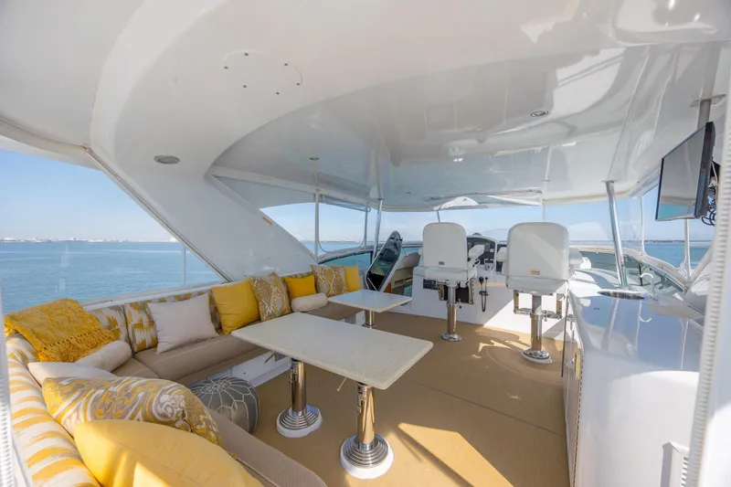 Slide: The Image of Luxurious 2007 Hatteras 64 Motor Yacht interior with elegant seating and ocean view. - 15