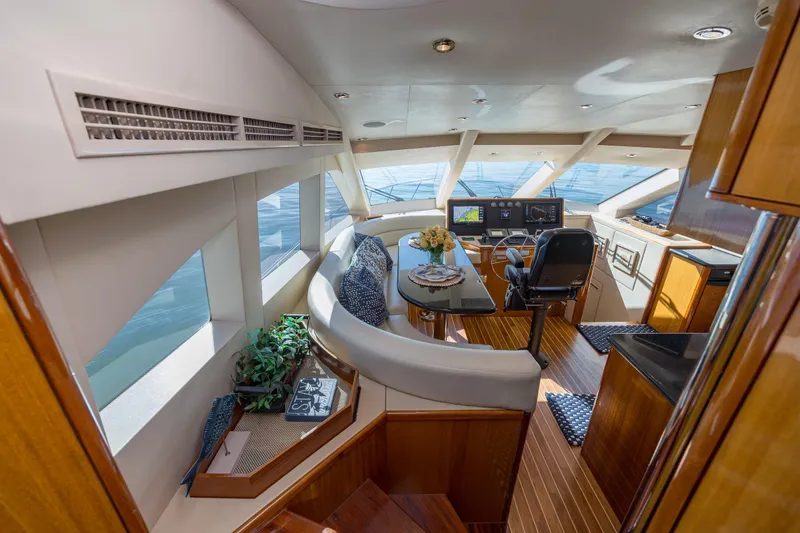 Slide: The Image of Luxurious interior of 2007 Hatteras 64 Motor Yacht with elegant seating and navigation area. - 17