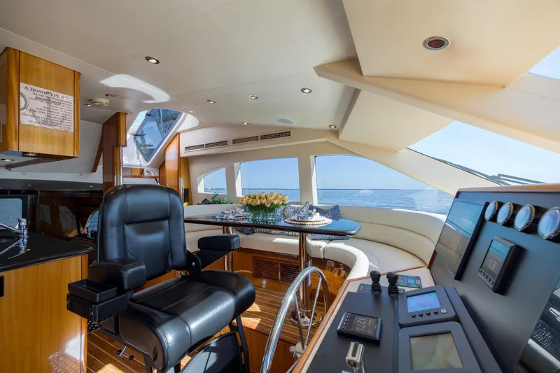 Slide: The Image of Luxurious interior of 2007 Hatteras 64 Motor Yacht with helm and panoramic windows. - 18