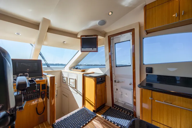 Slide: The Image of Luxurious interior of 2007 Hatteras 64 Motor Yacht with helm and panoramic windows. - 19