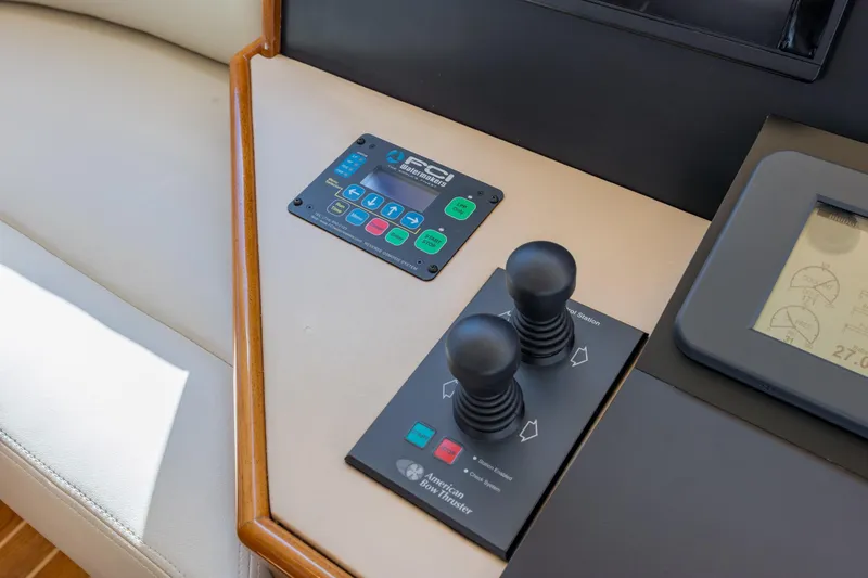 Slide: The Image of Control panel of a 2007 Hatteras 64 Motor Yacht with joysticks and display. - 20