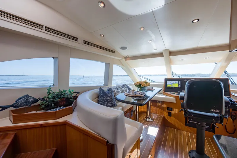 Slide: The Image of Luxurious interior of 2007 Hatteras 64 Motor Yacht with elegant seating and navigation equipment. - 25