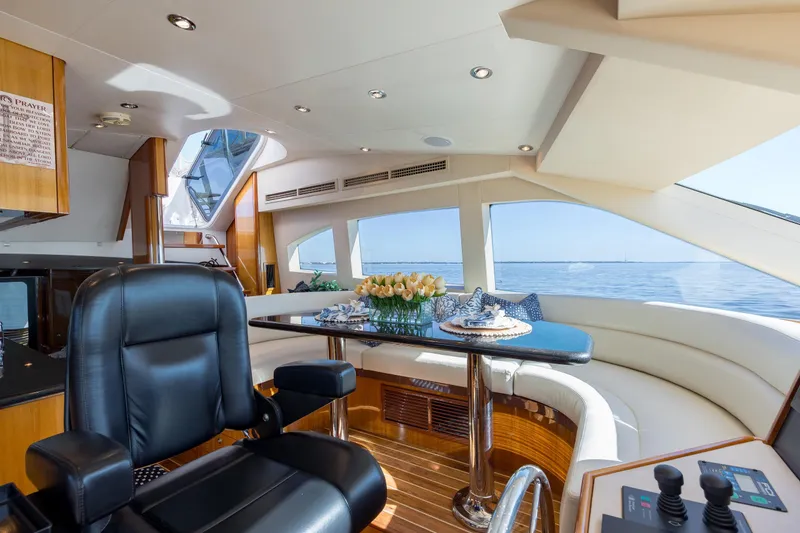 Slide: The Image of Luxurious interior of 2007 Hatteras 64 Motor Yacht with elegant seating and ocean view. - 26