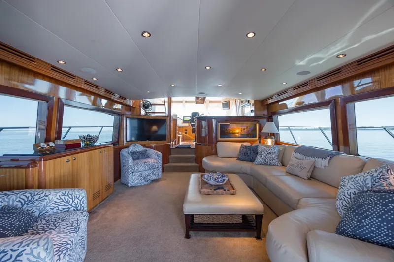Slide: The Image of Luxurious interior of 2007 Hatteras 64 Motor Yacht with elegant seating and panoramic windows. - 27