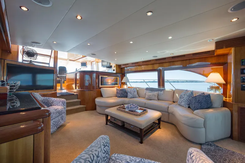Slide: The Image of Luxurious interior of 2007 Hatteras 64 Motor Yacht with elegant seating and panoramic windows. - 30