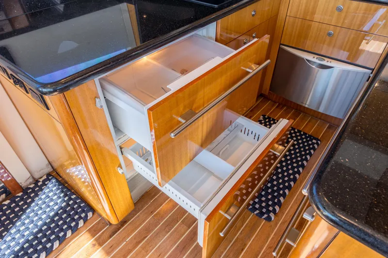 Slide: The Image of Luxurious kitchen drawers in a 2007 Hatteras 64 Motor Yacht, featuring sleek wood finish. - 35