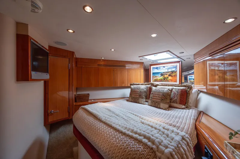Slide: The Image of Luxurious bedroom interior of 2007 Hatteras 64 Motor Yacht with cozy bedding and elegant wood finishes. - 38
