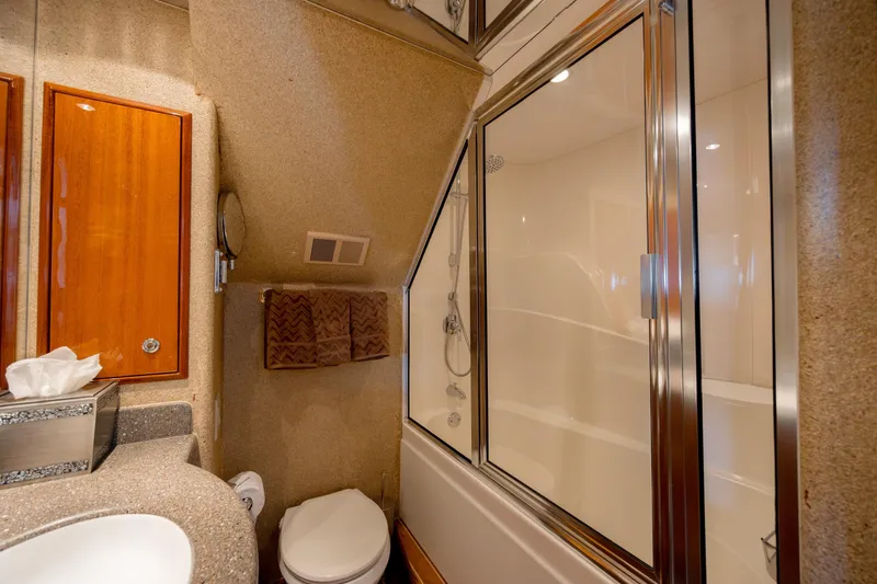 Slide: The Image of Luxurious bathroom in 2007 Hatteras 64 Motor Yacht with shower and elegant wood cabinetry. - 44
