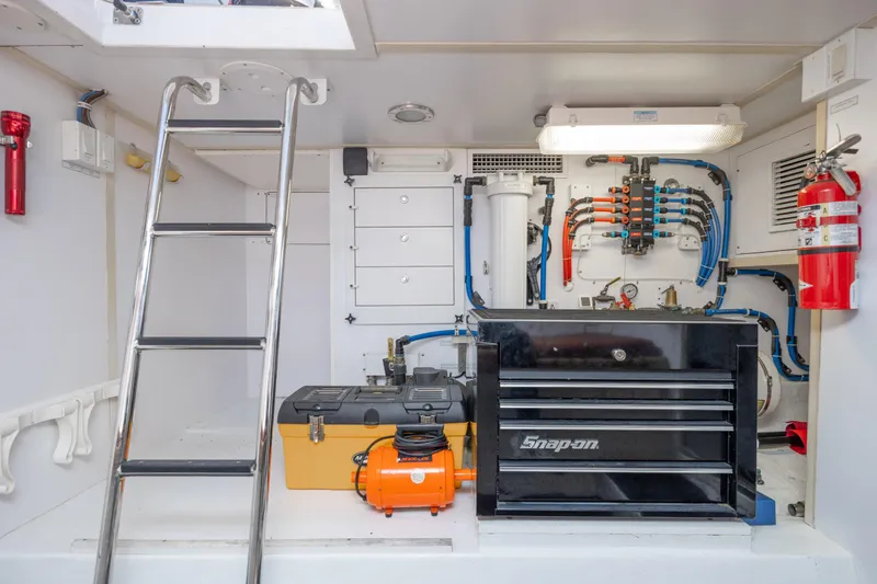 Slide: The Image of Engine room of 2007 Hatteras 64 Motor Yacht with tools and equipment. - 47