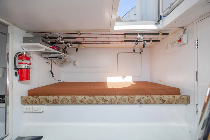 Slide: The Image of Interior of 2007 Hatteras 64 Motor Yacht with fishing rods and fire extinguisher. - 48