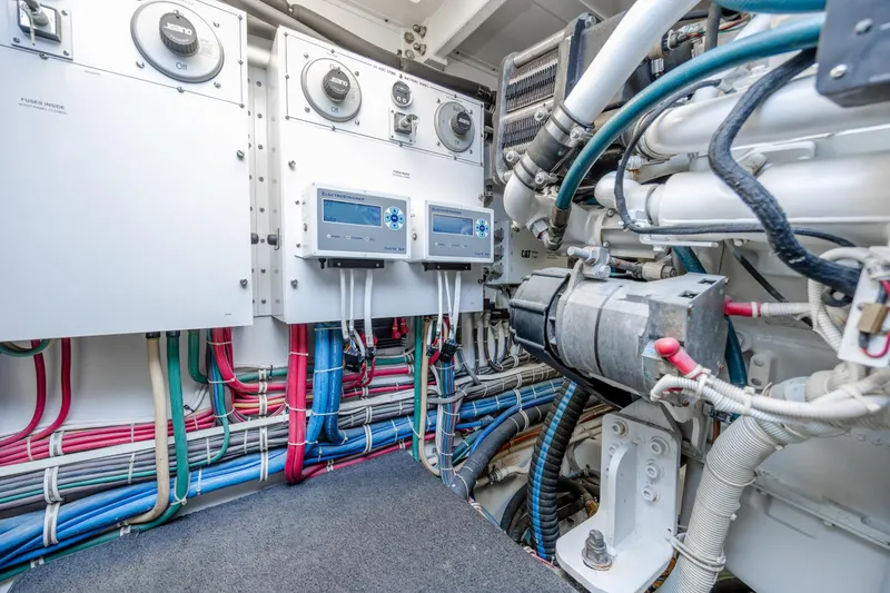 Slide: The Image of Engine room of 2007 Hatteras 64 Motor Yacht with wiring and control panels. - 52