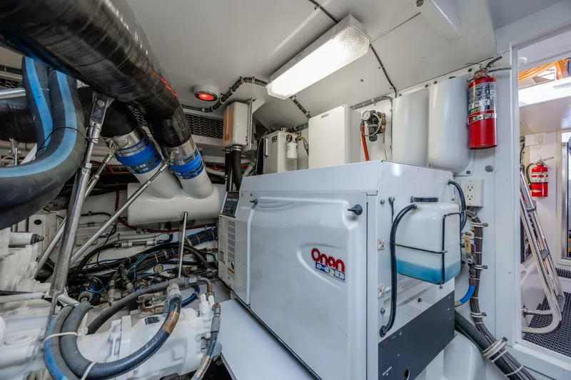 Slide: The Image of Engine room of 2007 Hatteras 64 Motor Yacht with Onan generator and fire extinguisher. - 53