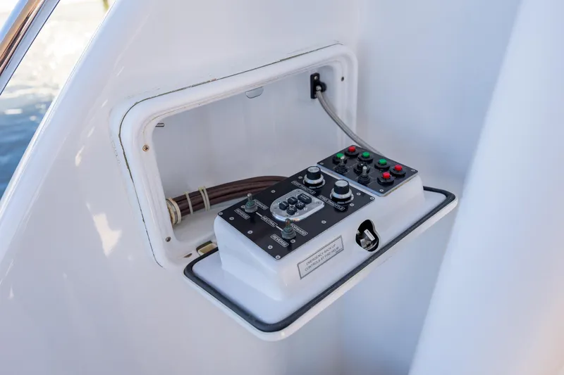 Slide: The Image of Control panel on a 2007 Hatteras 64 Motor Yacht, featuring various switches and buttons. - 54