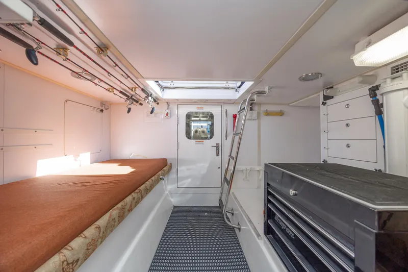 Slide: The Image of Interior of 2007 Hatteras 64 Motor Yacht with fishing rods and storage. - 55