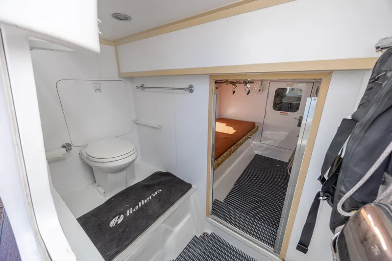 Slide: The Image of 2007 Hatteras 64 Motor Yacht interior with bathroom and cozy cabin. - 56