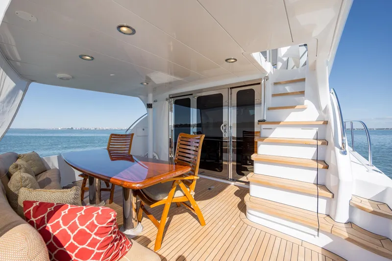 Slide: The Image of Luxurious 2007 Hatteras 64 Motor Yacht deck with elegant seating and ocean view. - 8