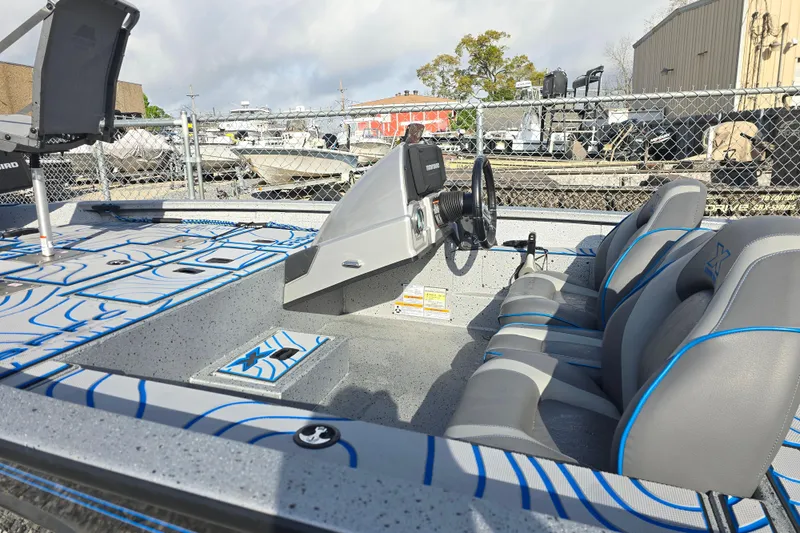 Slide: The Image of 2022 Xpress H18C Crappie boat interior with seating and steering console. - 11