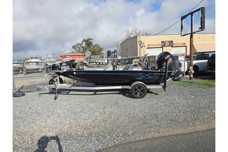 Slide: The Image of 2022 Xpress H18C Crappie boat on trailer in outdoor lot. - 2