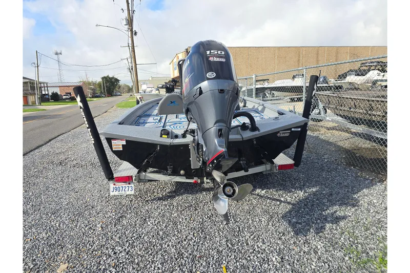 Slide: The Image of 2022 Xpress H18C Crappie boat with Yamaha 150 engine, parked on gravel. - 3