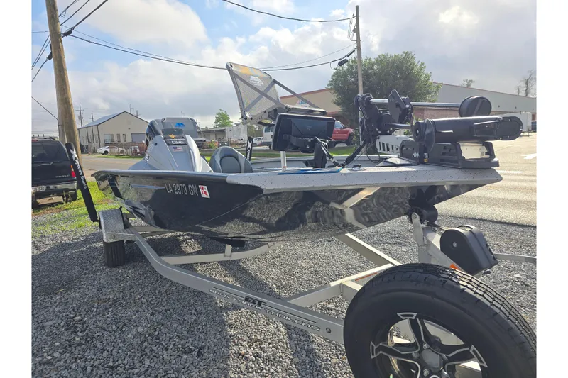 Slide: The Image of 2022 Xpress H18C Crappie boat on trailer, parked outdoors under cloudy sky. - 5