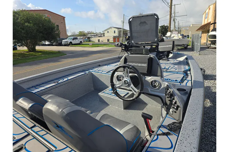 Slide: The Image of 2022 Xpress H18C Crappie boat interior with steering wheel and Humminbird electronics. - 8