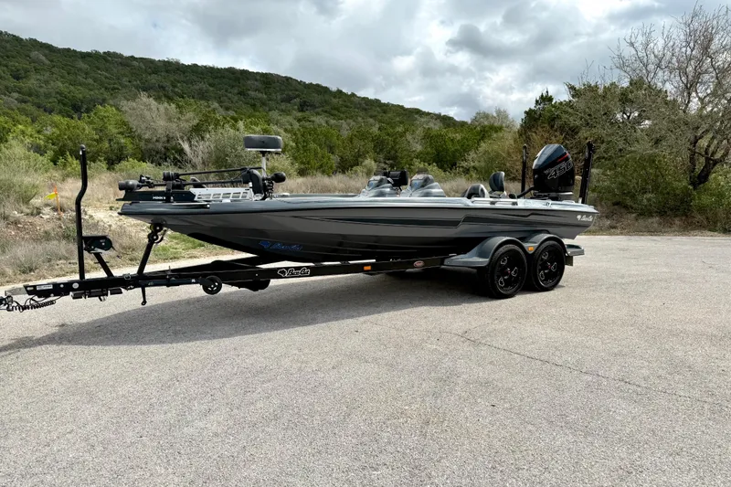 Slide: The Image of 2023 Bass Cat Jaguar STS boat on trailer, parked on a scenic road. - 10