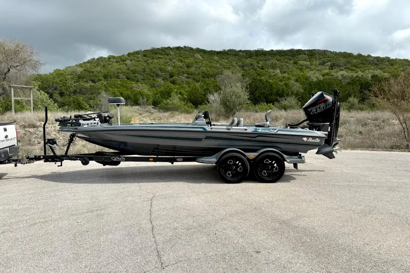 Slide: The Image of 2023 Bass Cat Jaguar STS boat on trailer, parked outdoors with scenic background. - 11