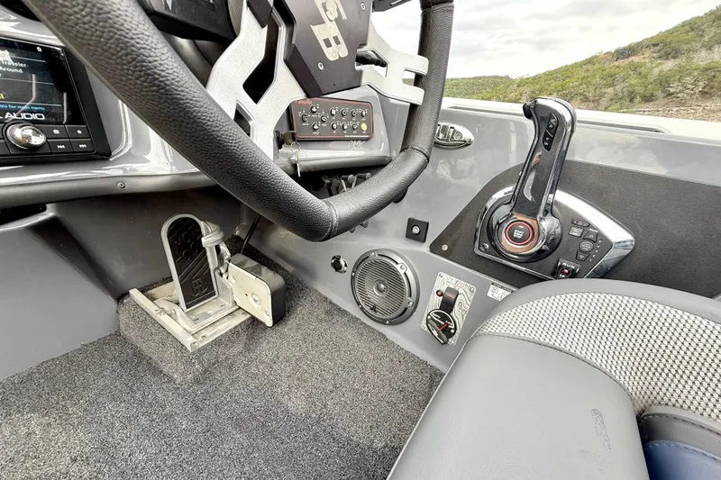 Slide: The Image of 2023 Bass Cat Jaguar STS boat cockpit with steering wheel and control panel. - 24