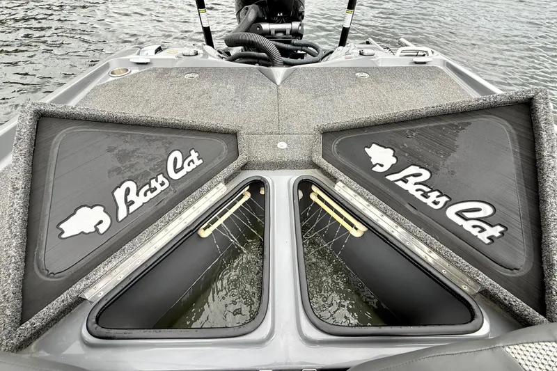 Slide: The Image of 2023 Bass Cat Jaguar STS boat interior with open storage compartments on the water. - 26