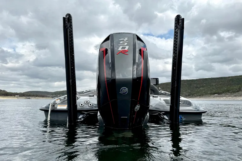 Slide: The Image of 2023 Bass Cat Jaguar STS boat with powerful 450R engine on a scenic lake. - 4