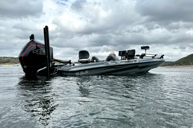 Slide: The Image of 2023 Bass Cat Jaguar STS boat on water under cloudy sky. - 5