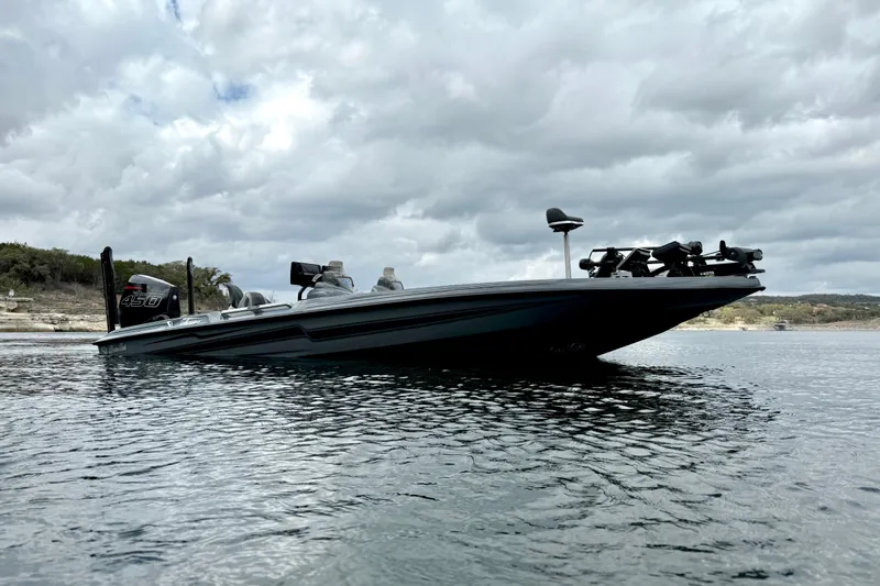 Slide: The Image of 2023 Bass Cat Jaguar STS boat on a lake under cloudy skies. - 7