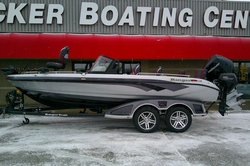 The Image of 2026 Ranger 620xFS Pro boat on trailer outside boating center. - 0