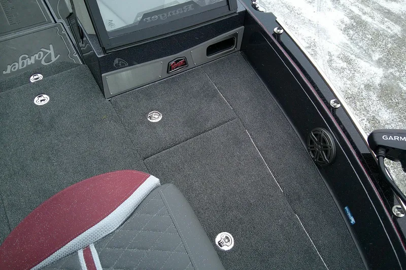 Slide: The Image of 2026 Ranger 620xFS Pro boat interior with carpeted deck and seating. - 14