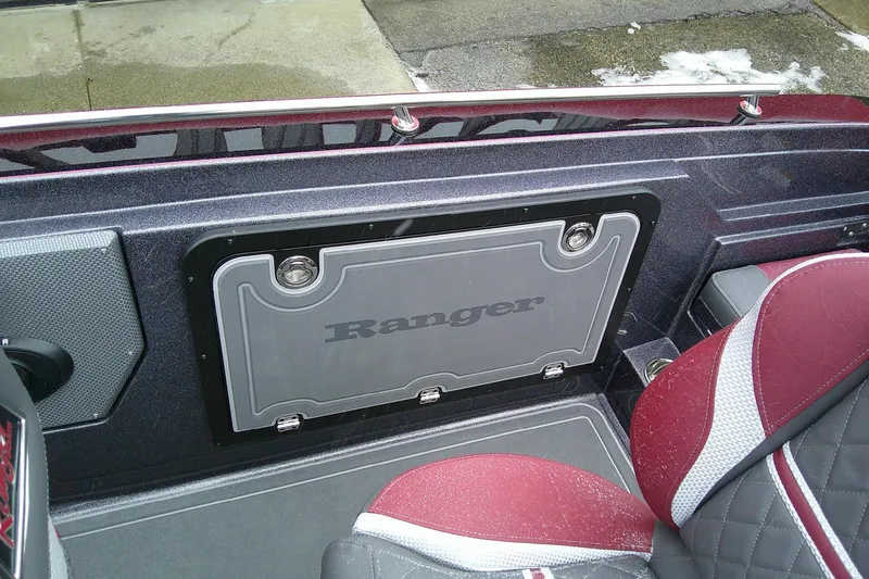 Slide: The Image of 2026 Ranger 620xFS Pro boat interior with red and gray seating and storage compartment. - 16